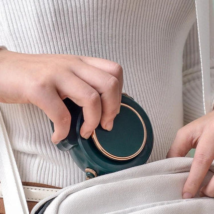 Compact USB-Powered Hanging Neck Fan for Outdoor Activities being placed into a backpack pocket, portable hands-free cooling