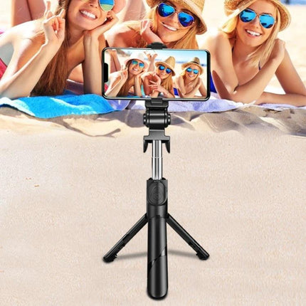 Compact Selfie Stick for Daily Travel and Event Photos capturing three friends on beach using tripod-mounted phone for group selfie