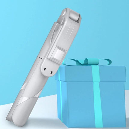 Compact Selfie Stick for Daily Travel and Event Photos compact foldable selfie stick next to gift box, pocket-sized travel accessory