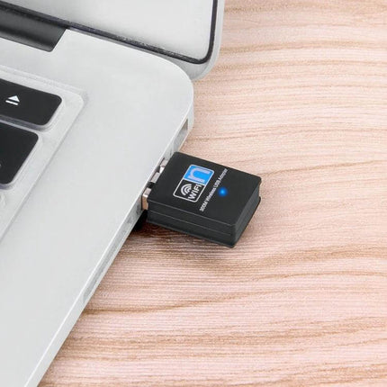 Mini USB Wireless Adapter for Easy Laptop Connectivity plugged into laptop USB port, compact 3.3 x 1.5 x 0.7 cm for travel and remote work