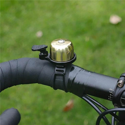 West Biking Copper Bicycle Bell Black For Everyday Riding on black handlebar, compact copper body and matte black mount for urban commuting