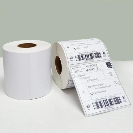 Thermal Self-Adhesive Shipping Label Paper in White Rolls showing two rolls, one with printed shipping labels ready for thermal printers