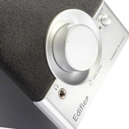 Edifier Compact Wooden Desktop Speaker With 3.5mm Jack close-up showing volume knob, power button and front fabric grille