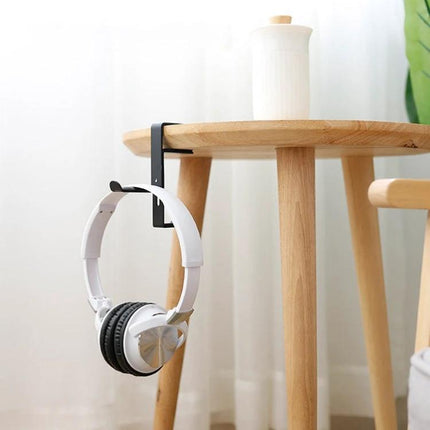 Metal Earphone Holder For Desk Black Compact Stand supporting white headphones on a wooden side table to reduce clutter