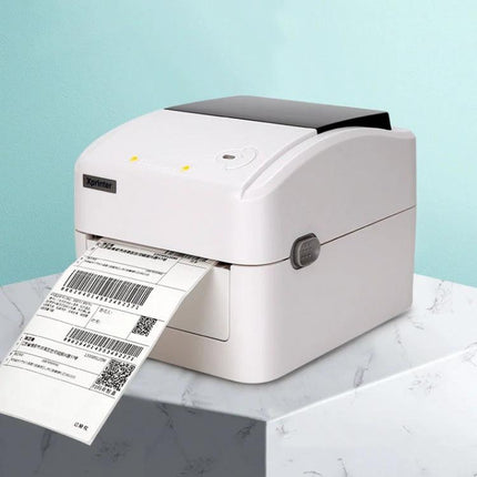 Xprinter XP-420B Thermal Label Printer with Bluetooth Option printing shipping labels on a countertop, 203 dpi resolution