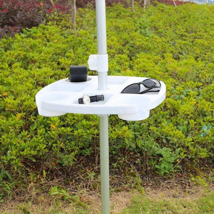Outdoor White PP Plastic Beach Umbrella Cup Holder Tray mounted on pole holding sunglasses, drink and sunscreen in grass