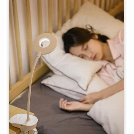 YAGE Clip Lamp for Everyday Home and Office Reading clipped to bedside table providing focused LED light for reading and bedside tasks