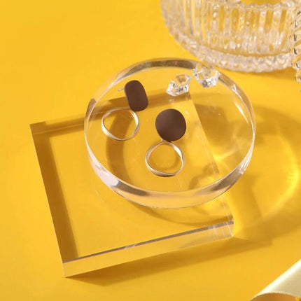 Acrylic Geometric Photo Props for Studio Backgrounds and Ornaments showcasing clear round and square acrylic props holding jewelry on a yellow background
