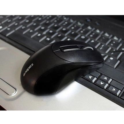 Cadeva Wired Computer Mouse with Three Buttons for Daily Use black ergonomic mouse on laptop keyboard