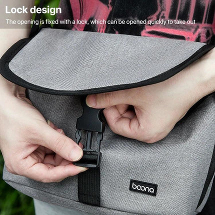 Baona Waterproof Camera Shoulder Bag for Everyday Use shown with lock-design buckle and person fastening waterproof Oxford cloth flap