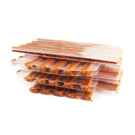 Rubber Strips for Quick Tire Fixes on Road Trips - stacked brown puncture repair strips for temporary tire patching while traveling