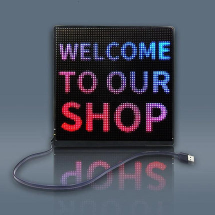 Bluetooth LED Screen for Portable Backpack Advertising showing multicolor 64x64 pixel panel displaying 'WELCOME TO OUR SHOP' with USB cable