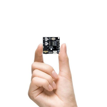 DIY Bluetooth 4.1 Audio Receiver Module for Car Audio Projects - compact board held between fingers for retrofitting car or DIY speaker