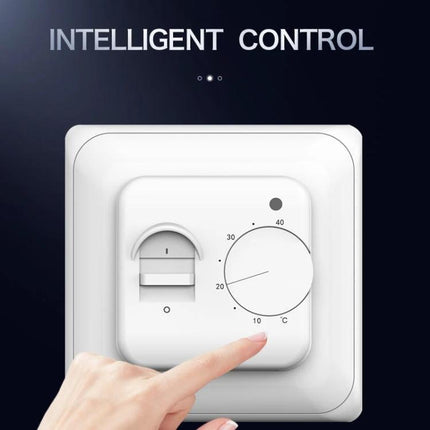 Mechanical Thermostat for Room Floor Heating Temperature Control — white dial thermostat on wall with finger adjusting temperature