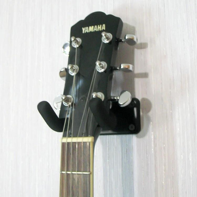 Wall Mounted Hook for Storing Guitars in Home Spaces - padded wall hook holding Yamaha acoustic guitar headstock, saves floor space
