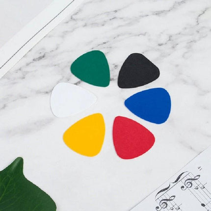 Guitar Picks for Everyday Music Practice at Home - six colorful guitar picks (green, black, white, blue, yellow, red) on marble surface