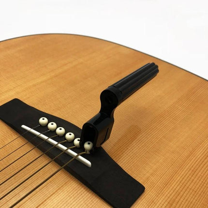 Guitar String Tool for Musicians' Daily Maintenance - quick-turn winding tool with grooved non-slip handle on acoustic guitar bridge