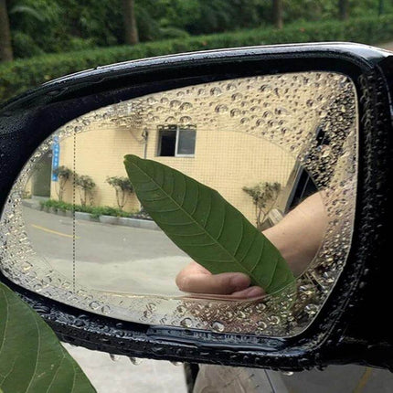 Set of 2 Rainproof Anti-Fog Films for Car Rearview Mirrors applied on wet side mirror showing clear central view and water beading around edges