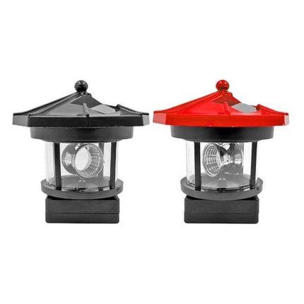 Outdoor Solar Rotating Lighthouse LED Garden Light Red shown on lawn edge with rotating white LED and solar top
