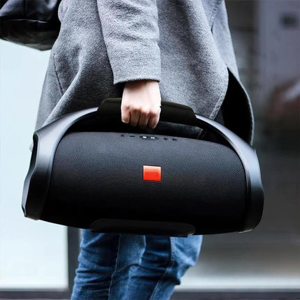 JBL Boombox Carry Strap With Padded Grip For Everyday Outdoor Use shown on speaker being carried outdoors
