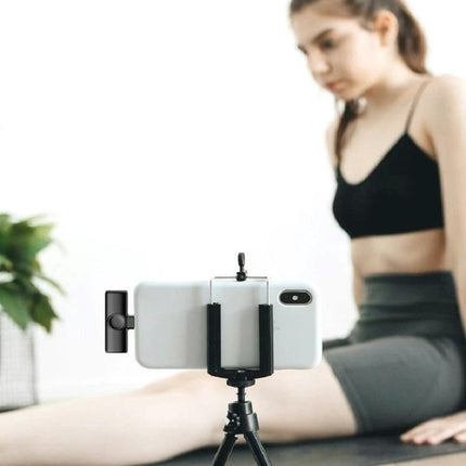 Lavalier Microphone for Everyday Mobile Video Recording attached to phone on tripod recording a woman exercising at home