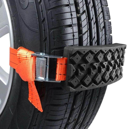 Emergency Car Escape Board for Mud, Snow, and Sand strapped to tire showing traction pad and orange ratchet strap