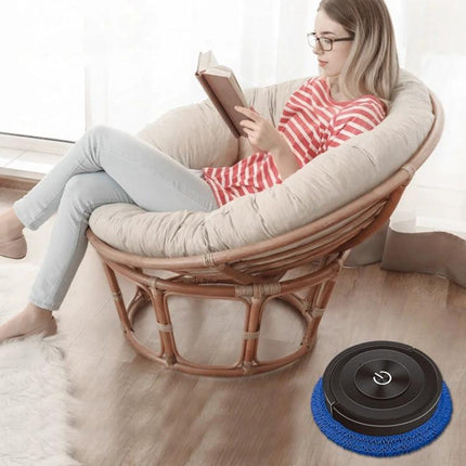 Automatic Floor Sweeping and Mopping Machine in Piano Black cleaning under chair while woman reads in living room