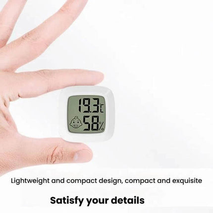 Baby Room Temperature And Humidity Meter Square For Nursery Use Daily compact square monitor showing 19.3°C and 58% held between fingers