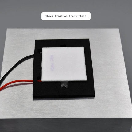 Thermoelectric Peltier Cooling Module for Electronic Projects showing frosted cold side mounted on aluminum plate with red and black leads