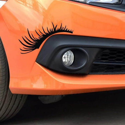 Decorative Car Eyelash Stickers for Headlights, 25x11 cm Per Pair applied to orange car headlight for playful customization