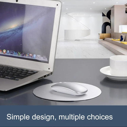 Wireless Mouse for Smooth Computer and Laptop Navigation on desk beside laptop with ergonomic rubber rollers and dual connectivity