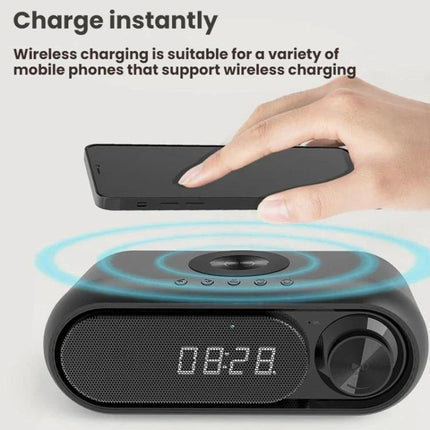 Compact Bluetooth Speaker With LED Clock And USB Charger on desk with wireless phone charging, LED time display and controls