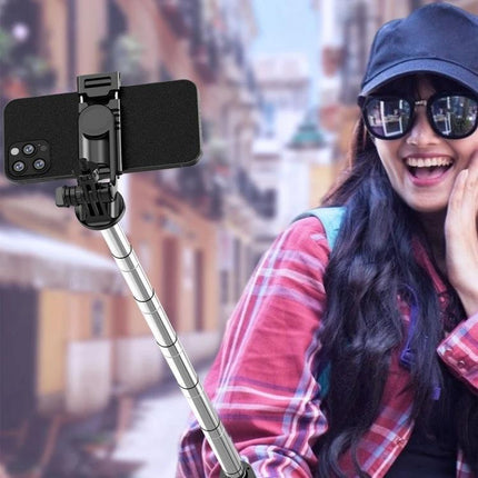 Extendable Selfie Stick for Travel and Daily Moments used by smiling traveler with phone on extended pole and built-in tripod