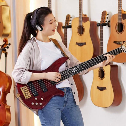 Student wearing Soyto Wired Headset for Everyday Student Music Practice while playing bass guitar in a studio