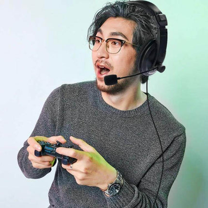 Soyto Ergonomic Gaming Headset Comfort Fit For PC And PS4 worn by gamer with mic playing controller, breathable leather earmuffs