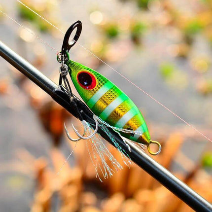 Proberos Sea Fishing Metal Bait 60g With Conical Reflective Profile hanging on rod showing green striped reflective lure and treble hook