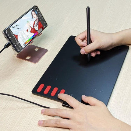 VINSA T505 Drawing Tablet for Artists and Designers showing hands sketching on a black tablet connected to a smartphone with artwork visible