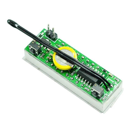 Versatile Digital Clock with Thermometer and Voltmeter Functions compact module showing circuit board, battery, probe and connectors for electronics and automotive use