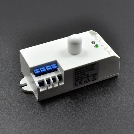 Microwave Radar Sensor for Indoor Human Motion Detection white 5.8GHz module on dark surface for lighting and security automation