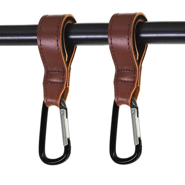 Two Pack Baby Stroller Carabiner Hooks, Brown and Black hanging from stroller bar, leather strap with black carabiners for bags and bottles