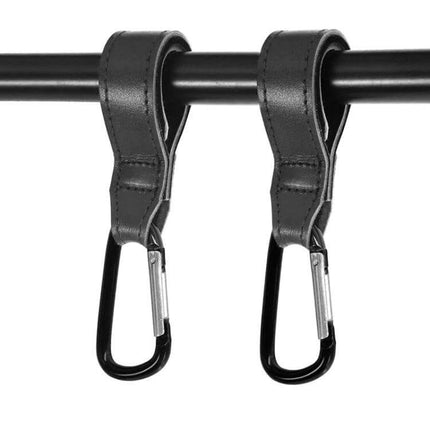 Two Pack Baby Stroller Carabiner Hooks, Brown and Black hanging from stroller handle, durable cowhide straps with black carabiners