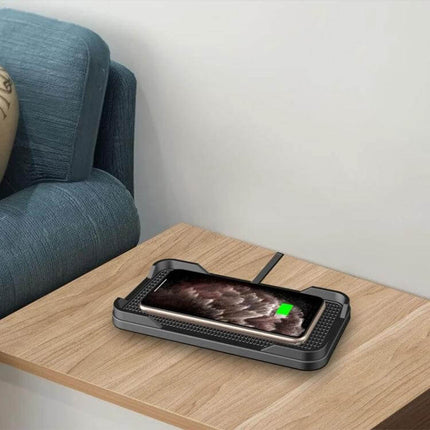 POLMXS Car Anti Slip Wireless Charger For Qi Phones on a wooden table charging a smartphone with anti-slip bump design