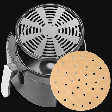 Oil Absorbing Air Fryer Paper 23cm Square For Easy Cleanup - 23cm round perforated liner shown on air fryer basket, 100 silicone-coated sheets pack