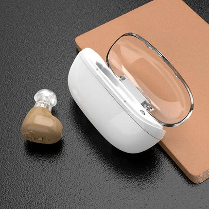 Portable Rechargeable Hearing Aid for Daily Sound Assistance compact beige in charging case on desk