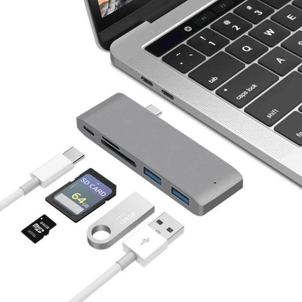 USB-C Multi-Port Docking Station with HDMI and Card Reader connected to laptop with SD cards, USB drives and HDMI-ready ports for travel and remote work
