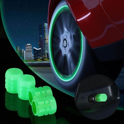 Luminous Tire Valve Caps 4pc Set for Cars and Motorcycles glowing green valve caps beside car wheel at night