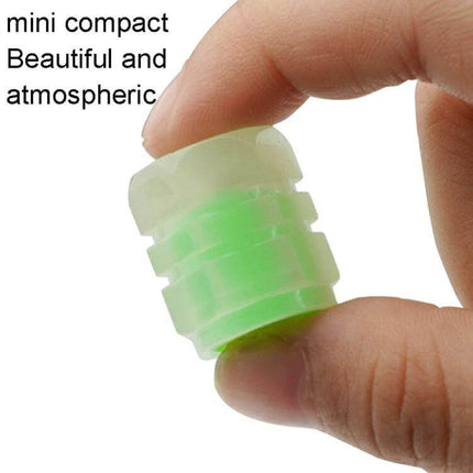 Luminous Tire Valve Caps 4pc Set for Cars and Motorcycles - glowing green ABS valve cap held between fingers, compact luminous design for visibility