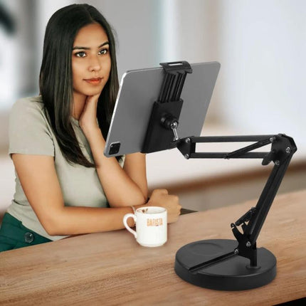 Compact Folding Stand for Everyday Home Device Holding showing tablet on adjustable arm beside woman with coffee