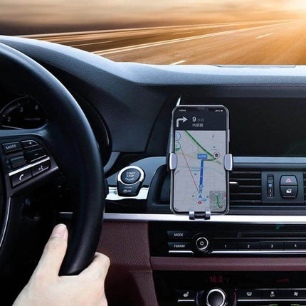 Universal Aluminum Gravity Car Phone Holder For Hands Free Driving mounted on car vent holding phone with GPS navigation
