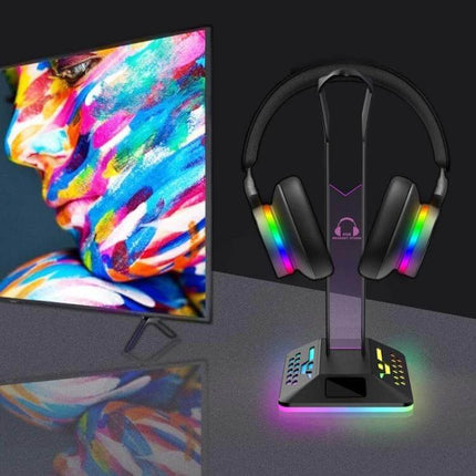Headset Stand With RGB Lighting And Dual USB Charging Ports on desk holding headphones, RGB glow and two USB charging ports